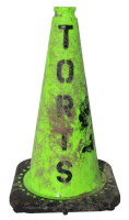 lime green safety cone spray paint stenciled with TORTS, and splattered with dirt and grime